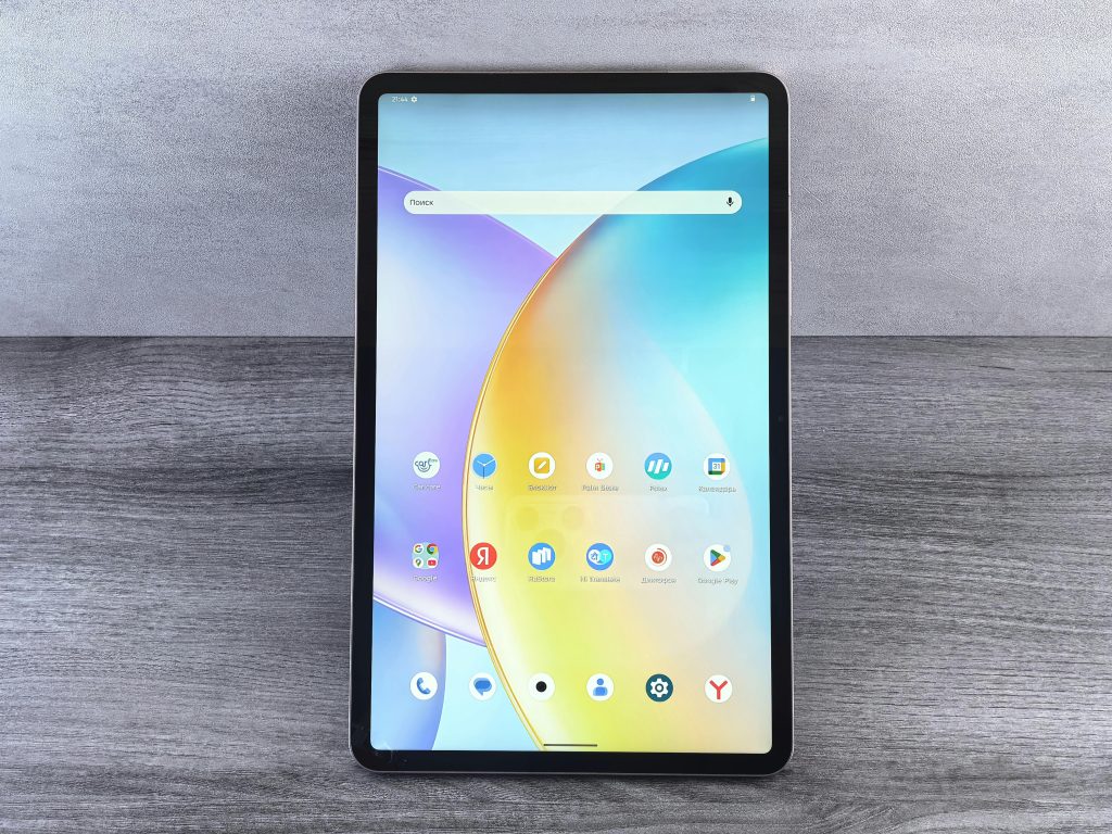 Front view of a modern tablet showing a colorful home interface with various app icons on display.