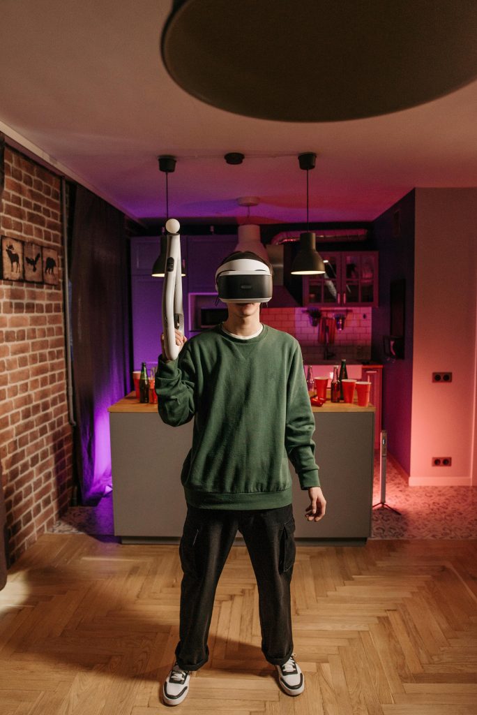 Person enjoying virtual reality gaming experience in a cozy home setting.